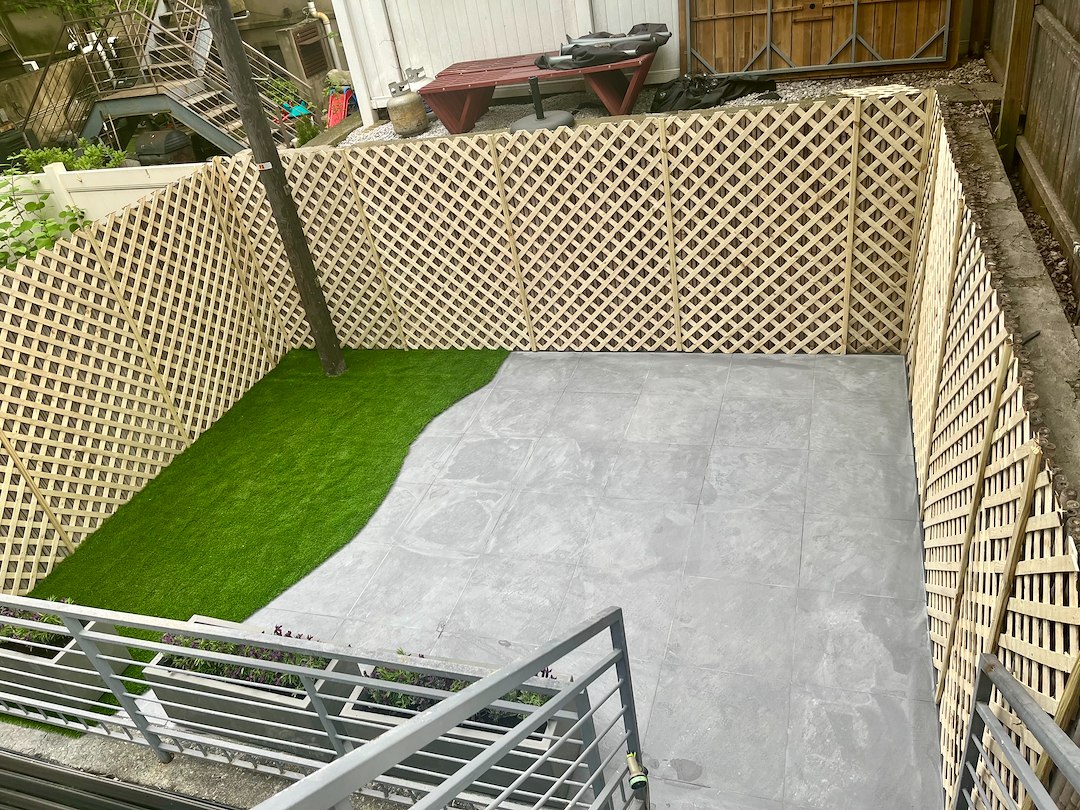 Crown Heights Transformation: Porcelain Bluestone Tile, Concrete Planters, Artificial Turf, and Cedar Lattice Wall – $6,500